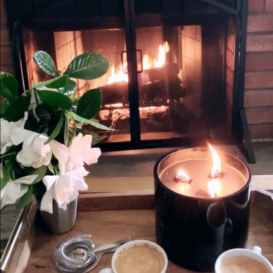 beautiful wide wick gardenia scented candles and gardenias in vase by fire