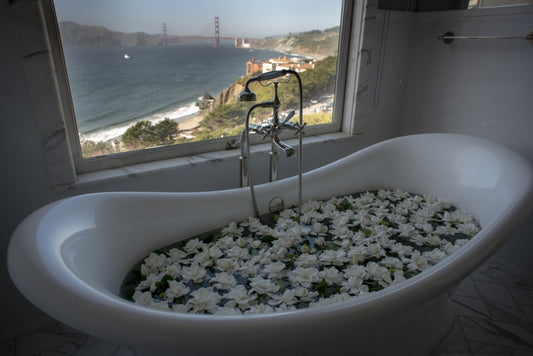 floating white gardenia flowers in bathtub