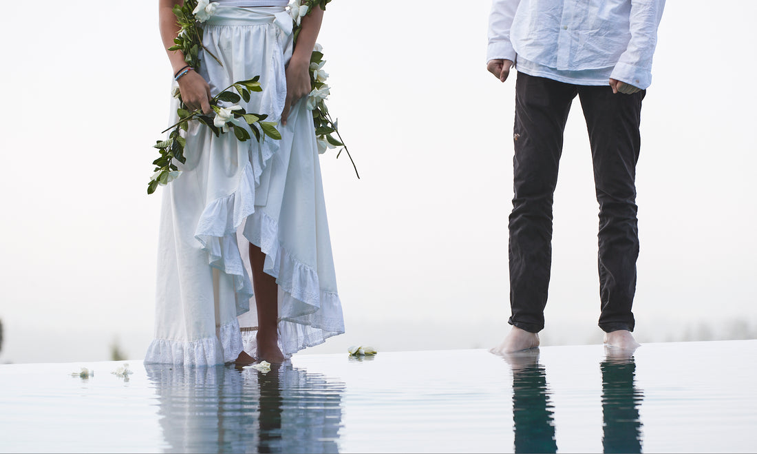 man and woman in romantic setting with gardenias